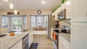 A modern kitchen with granite countertops, stainless steel appliances, and a bay window with a view. - Cozy Country Livin! Gem 17 Mi to Lakepoint Sports (Woodstock)