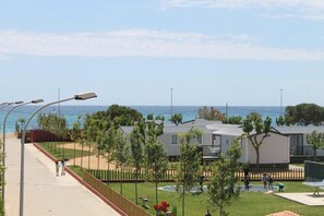 Stunning coastal homes line a scenic walkway, offering ocean views.