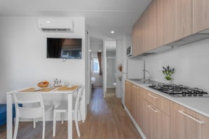 Fridge, stovetop, high chair, cookware/dishes/utensils