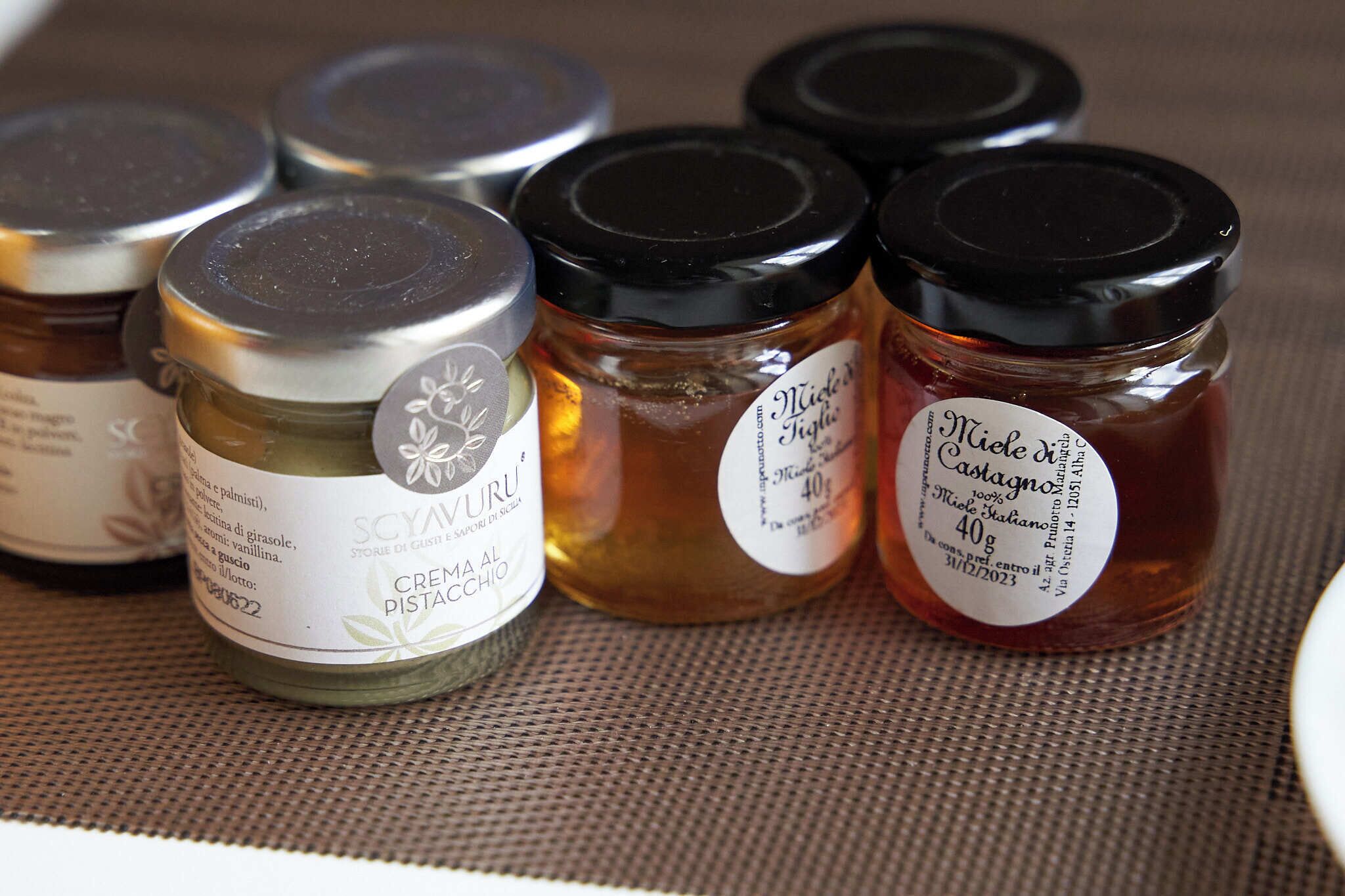 Several jars of food products on a table.