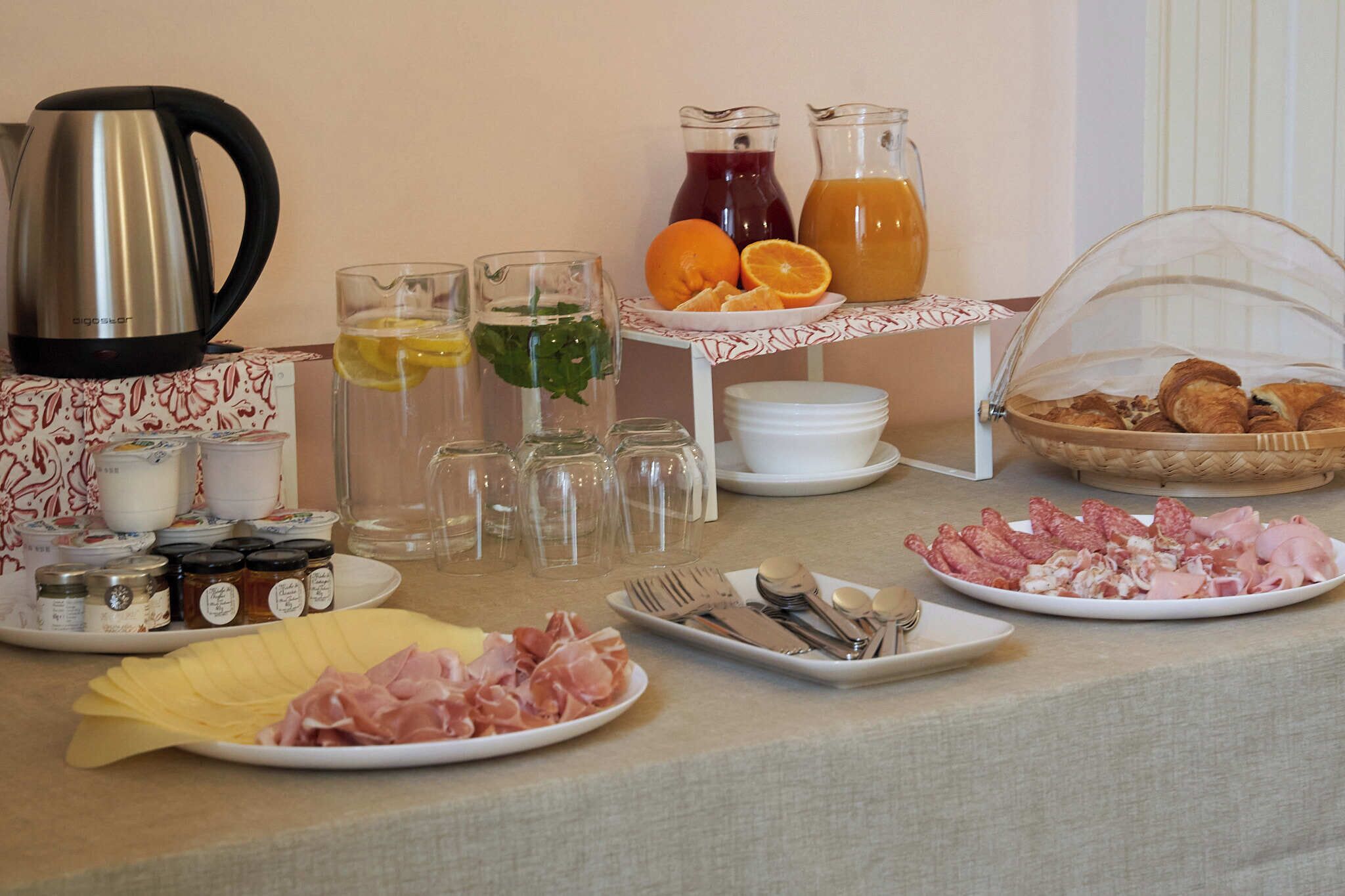 A breakfast buffet with various food items, beverages, and condiments.