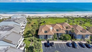 A coastal hotel with multiple buildings, a parking lot, and a view of the ocean. - 604 Surf Villas Oceanfront Luxury Condo at Sawgrass Beach Club in Beautiful PVB! (Ponte Vedra Beach)