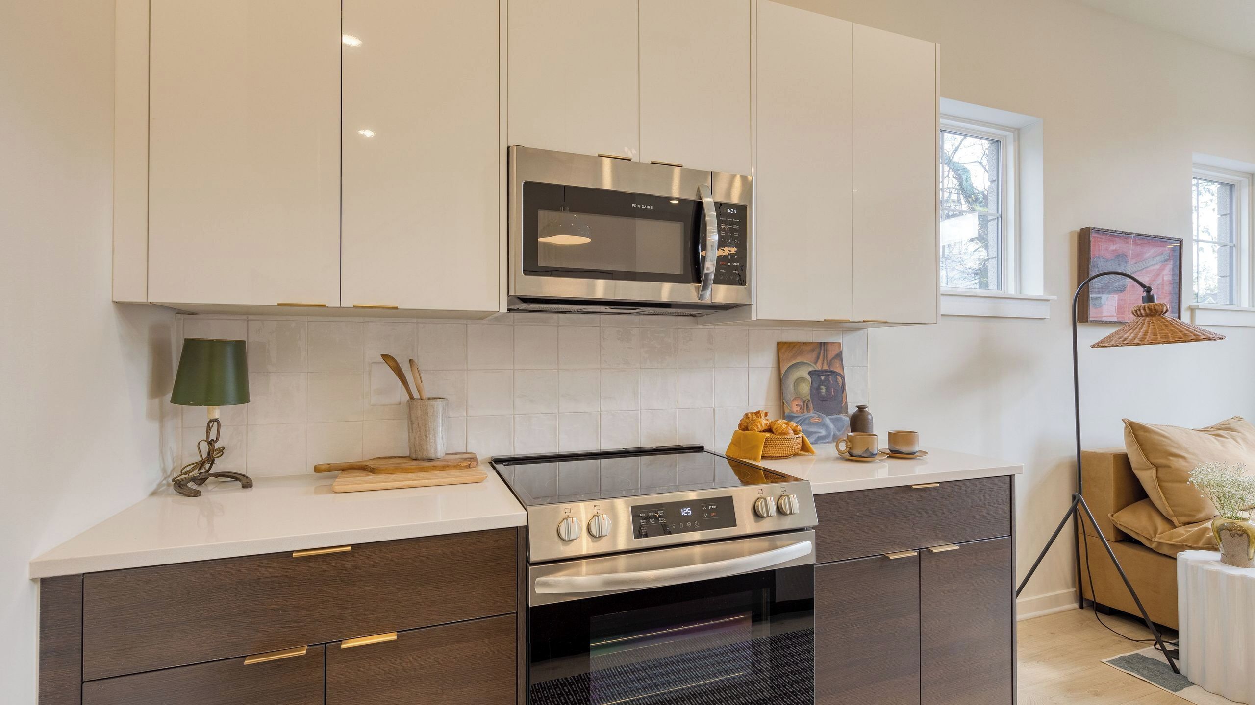 A modern kitchen with a built-in microwave, oven, and stovetop.