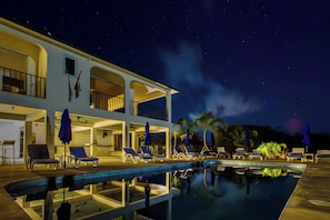 A two-story hotel with a swimming pool, lounge chairs, and umbrellas. - Club Vieques - Adults Only Resort - LGBT Friendly (Vieques)