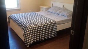 A bedroom with a bed, a nightstand, a window, and a ceiling light. - Room in Guest Room - Queen Room 2 Brampton Toronto Canada (Brampton)