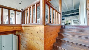 A wooden staircase with a railing, leading to an upper level. - Game Room, Trails! 30-Acre Lakefront Streetman Gem (Streetman)