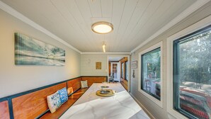 A long, white marble counter with a bench seating area on one side, a large window on the other, and a ceiling light fixture. - Game Room, Trails! 30-Acre Lakefront Streetman Gem (Streetman)