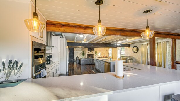 A spacious kitchen with a large island, modern appliances, and pendant lighting. - Game Room, Trails! 30-Acre Lakefront Streetman Gem (Streetman)