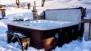 A hot tub in a snowy outdoor setting.