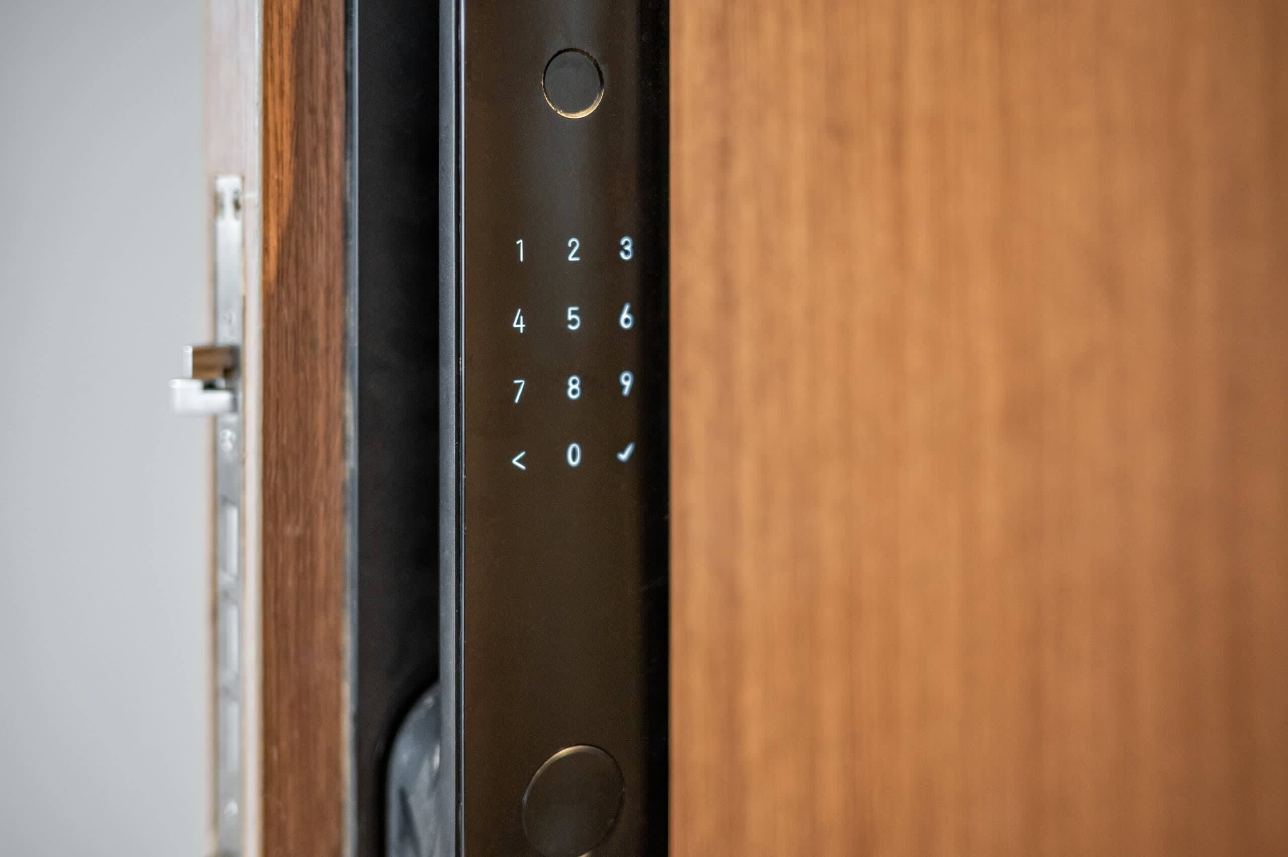A close-up of a door with a numeric keypad lock.