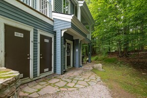 A two-story building with a stone-paved entrance and a covered porch.