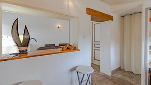 A modern kitchen with a wooden countertop, a large mirror, and a unique light fixture. - Escape to Les Pouges – Renovated House with Garden, Fast Wi-Fi, Barbecue (Saint Avit Saint Nazaire)