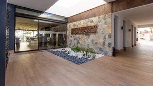 A modern building with a stone wall and a sign that reads "La Reserva".