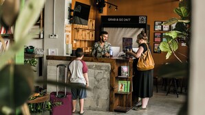 A coffee shop interior with a counter, bookshelves, and a 'Grab & Go' sign. - Domus Tlv (Tel Aviv)