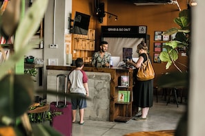 A coffee shop interior with a counter, bookshelves, and a 'Grab & Go' sign. - Domus Tlv (Tel Aviv)