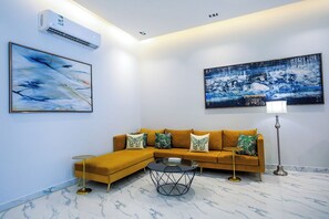 Deluxe Villa, Patio, Pool View | Living area