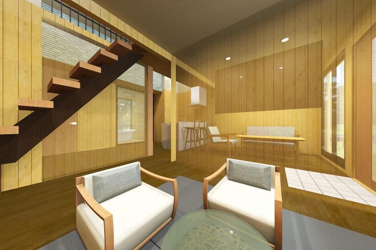 A modern interior with a wooden staircase, a sofa, a glass table, and a view through large windows.