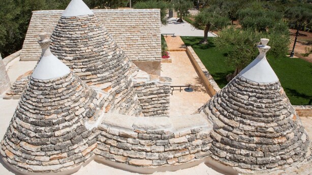 A stone-roofed building with multiple conical structures.