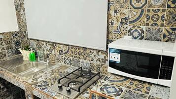 Microwave, cookware/dishes/utensils, dining tables