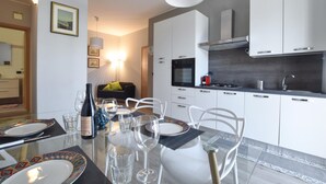 A modern kitchen with white cabinets, a built-in oven, and a gas stove. - 2 bedroom gorgeous apartment in Trappitello (Trappitello)