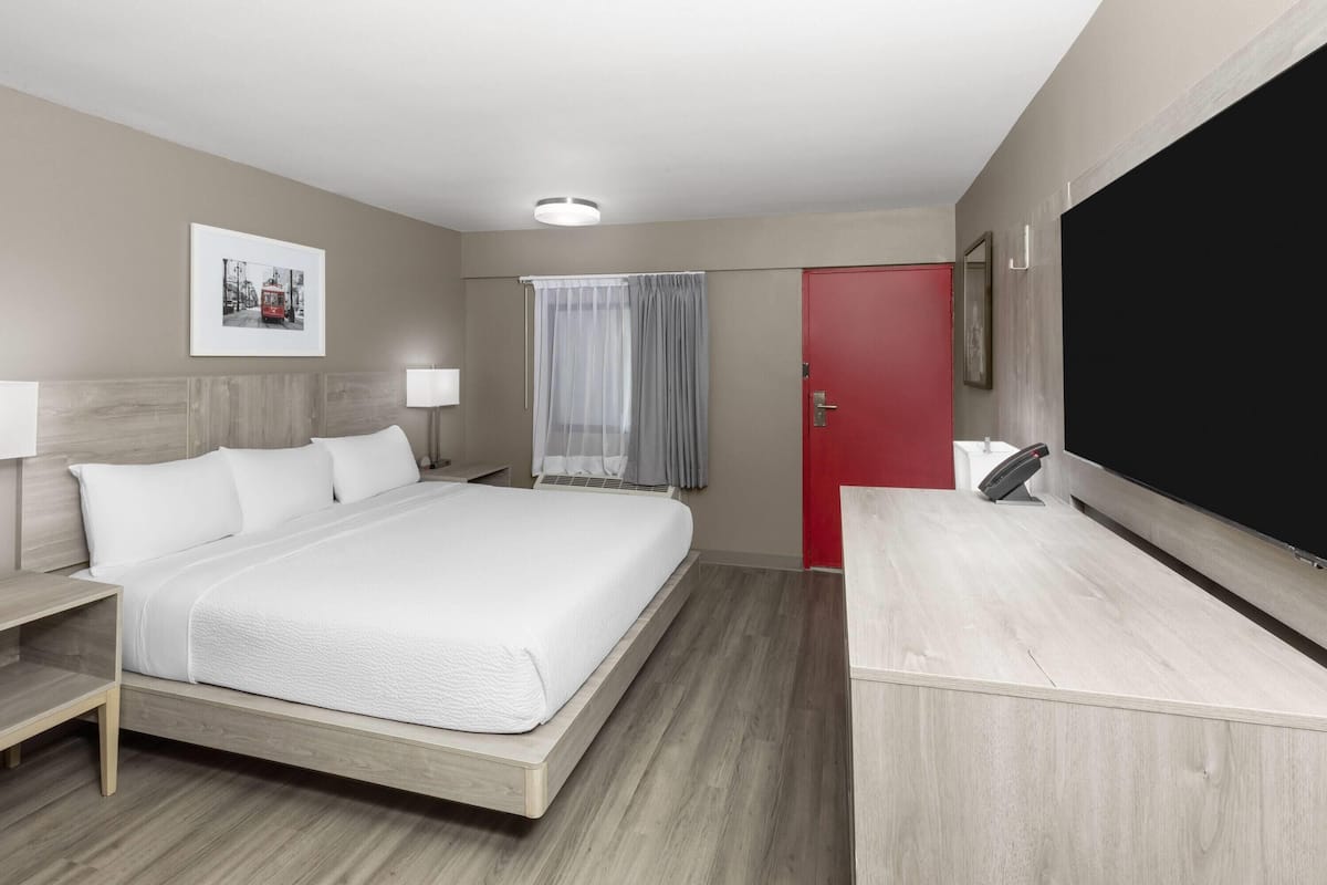 Room, 1 King Bed, Non Smoking (Mobility, Roll-in Shower) | Desk, laptop workspace, blackout drapes, iron/ironing board
