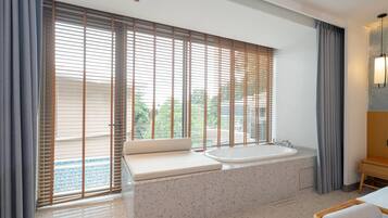 Deluxe Room, 1 King Bed, Pool Access | In-room safe, iron/ironing board, free cribs/infant beds, bed sheets