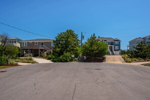 A residential street with houses, a driveway, and a mailbox. - Da Kine By Da C: Dog-Friendly, Oceanside Home in Ocean Sands, Private Heated Pool (Corolla)