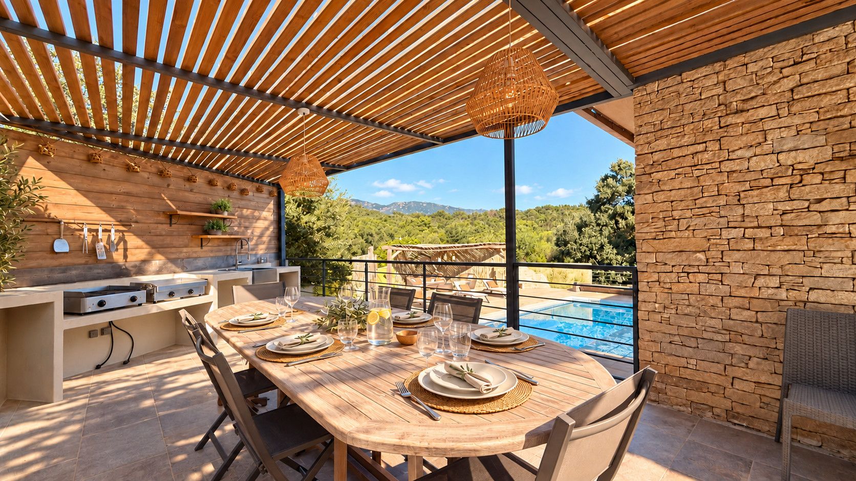 An outdoor dining area with a wooden table set for four, a grill station, and a view of a swimming pool.
