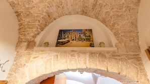A stone archway with a framed picture of a building.