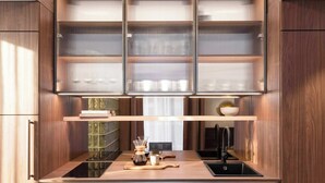 Une cuisine moderne dotée de meubles encastrés, d’une machine à café et d’un plan de travail élégant.