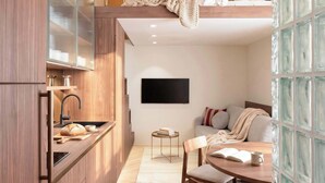 Une cuisine moderne avec des meubles en bois, un four encastré et un luminaire suspendu.