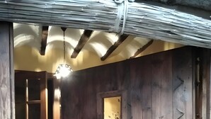 A wooden interior with a tiled floor, a small window, and a door.