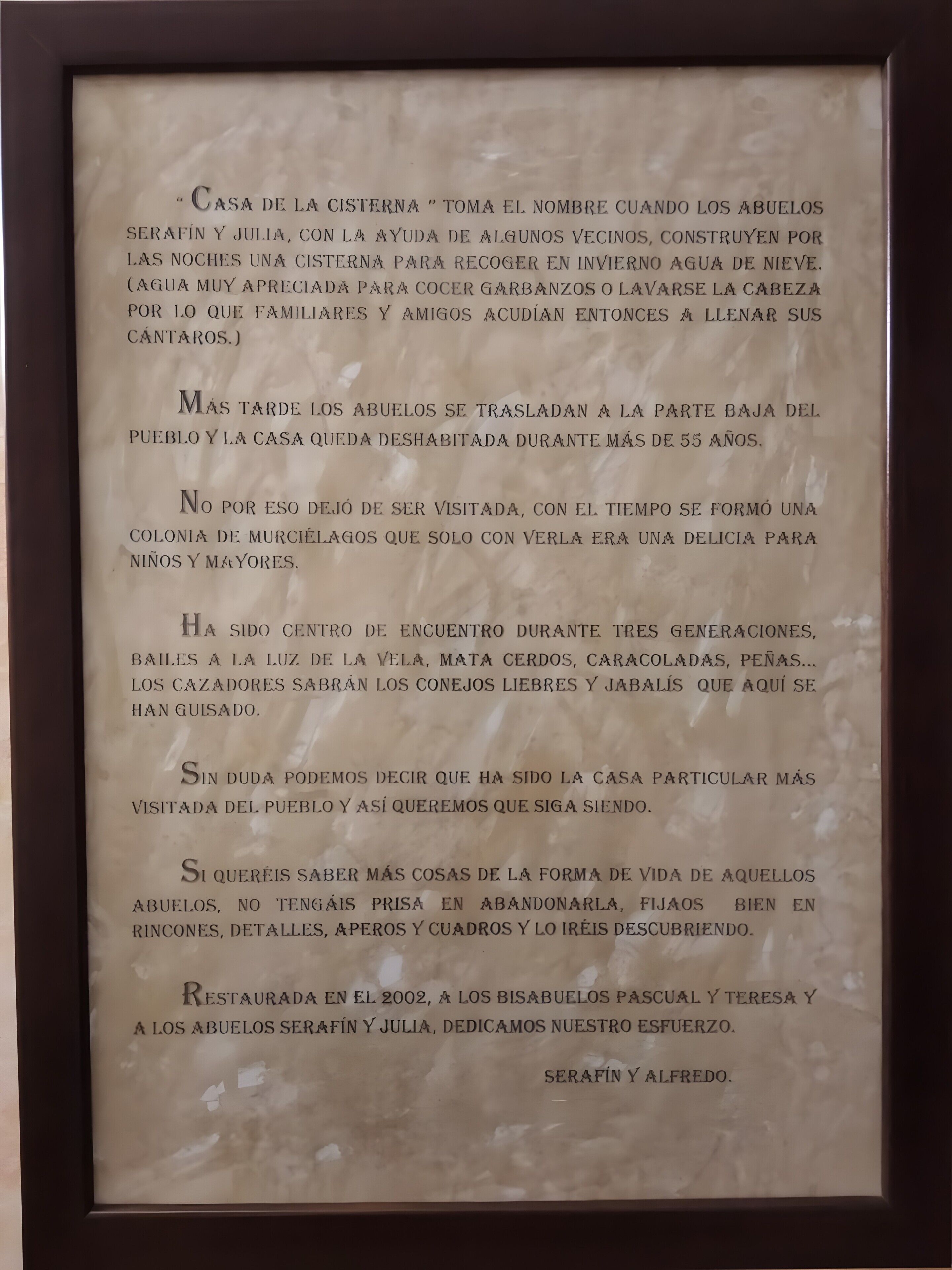 A framed text document with a historical narrative about a house.
