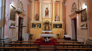 A church interior with an altar, pews, and religious statues. - Country House 'La Cisterna II' (Pina de Montalgrao)