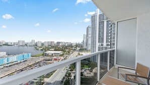 A high-rise building with a view of a marina and cityscape. - LUXURIOUS APARTMENT FRONT OF THE BEACH IN SUNNY ISLE (Sunny Isles Beach)