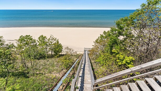 A wooden staircase leading to a beach with a clear view of the ocean. - Luxury Lakefront Escape | 6 Bedrooms & Pet Friendly (West Olive)