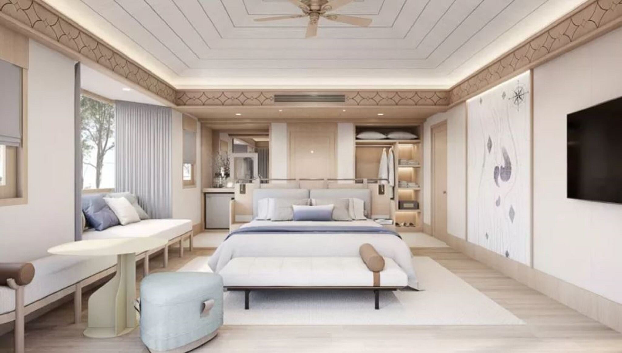 A bedroom with a bed, bedside table, seating area, and a TV.