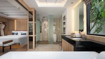 A modern hotel room with a large bed, a separate bathroom, and a large window with a view.