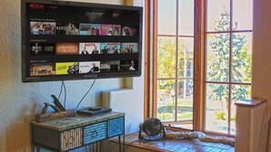 A television mounted on a wall displaying various Netflix shows. - Studio 508 Downtown Leadville (Leadville)