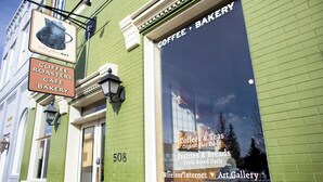 A green building with a window displaying "Coffee & Bakery" and "Pastries & Breads Fresh Baked Daily". - Studio 508 Downtown Leadville (Leadville)