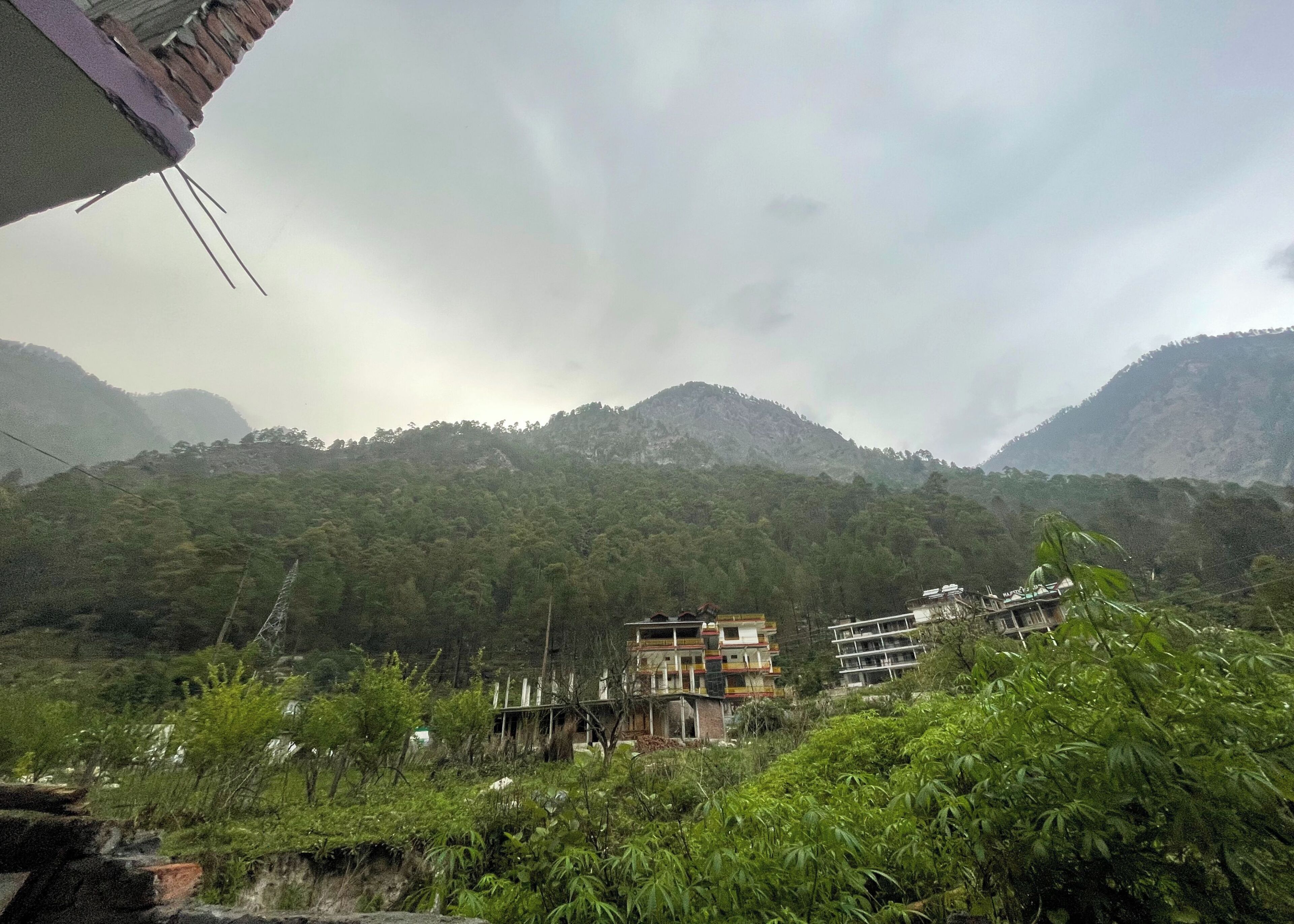 A mountainous landscape with buildings nestled among the trees.