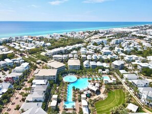 A resort with a central swimming pool, multiple buildings, and a view of the ocean. - Seacrest Lagoon Pool, Pet Friendly, 5 Bikes, Quick Walk to the Beach 'FantaSEA' (Inlet Beach)