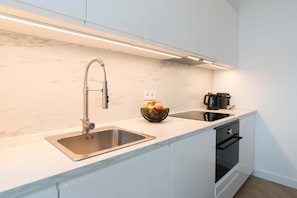 Fridge, stovetop, dishwasher, coffee/tea maker
