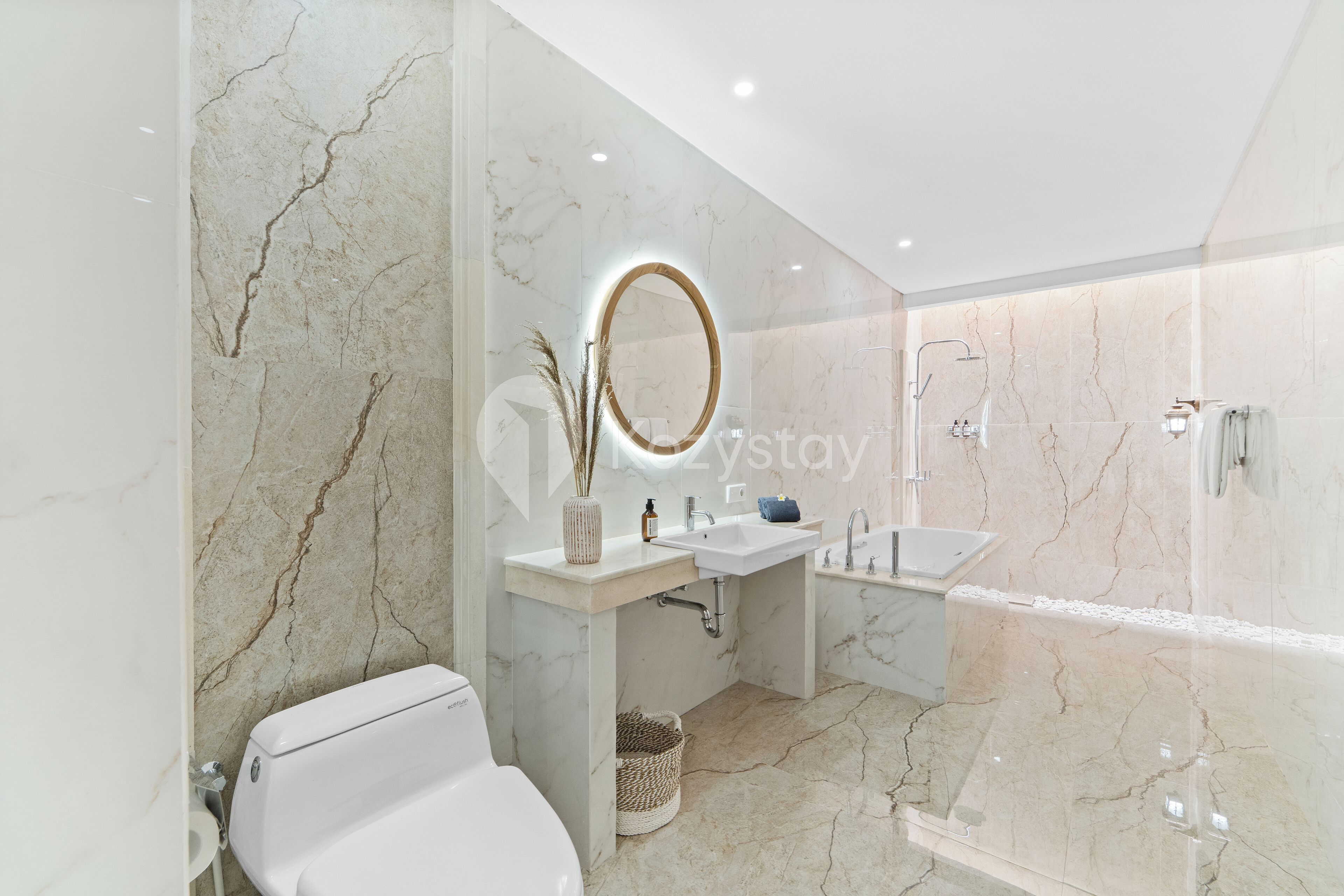 A modern bathroom with a toilet, sink, and shower.