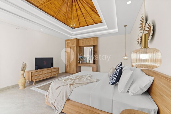 A modern bedroom with a wooden bed, a TV, a wooden cabinet, and a ceiling fan.