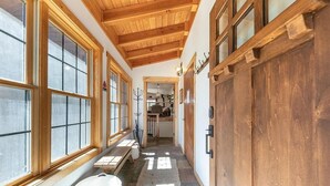 A hallway with wooden beams, large windows, and a bench. - 4 BR Retreat with Lakeview and Hot Tub (Kings Beach)