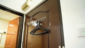 A brown door with a metal hanger rack attached to it. - B Link Hotel (Kulai)
