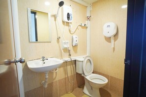 A bathroom with a sink, toilet, and shower. - B Link Hotel (Kulai)