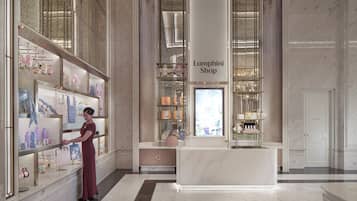 A luxury boutique with marble floors and a central reception desk.