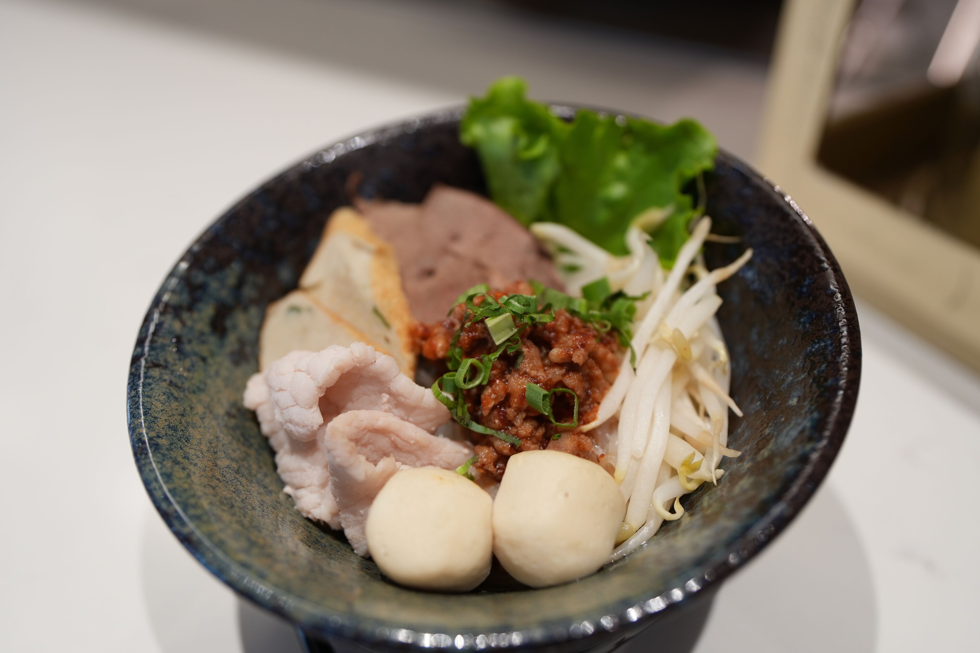 A bowl of food with various ingredients.